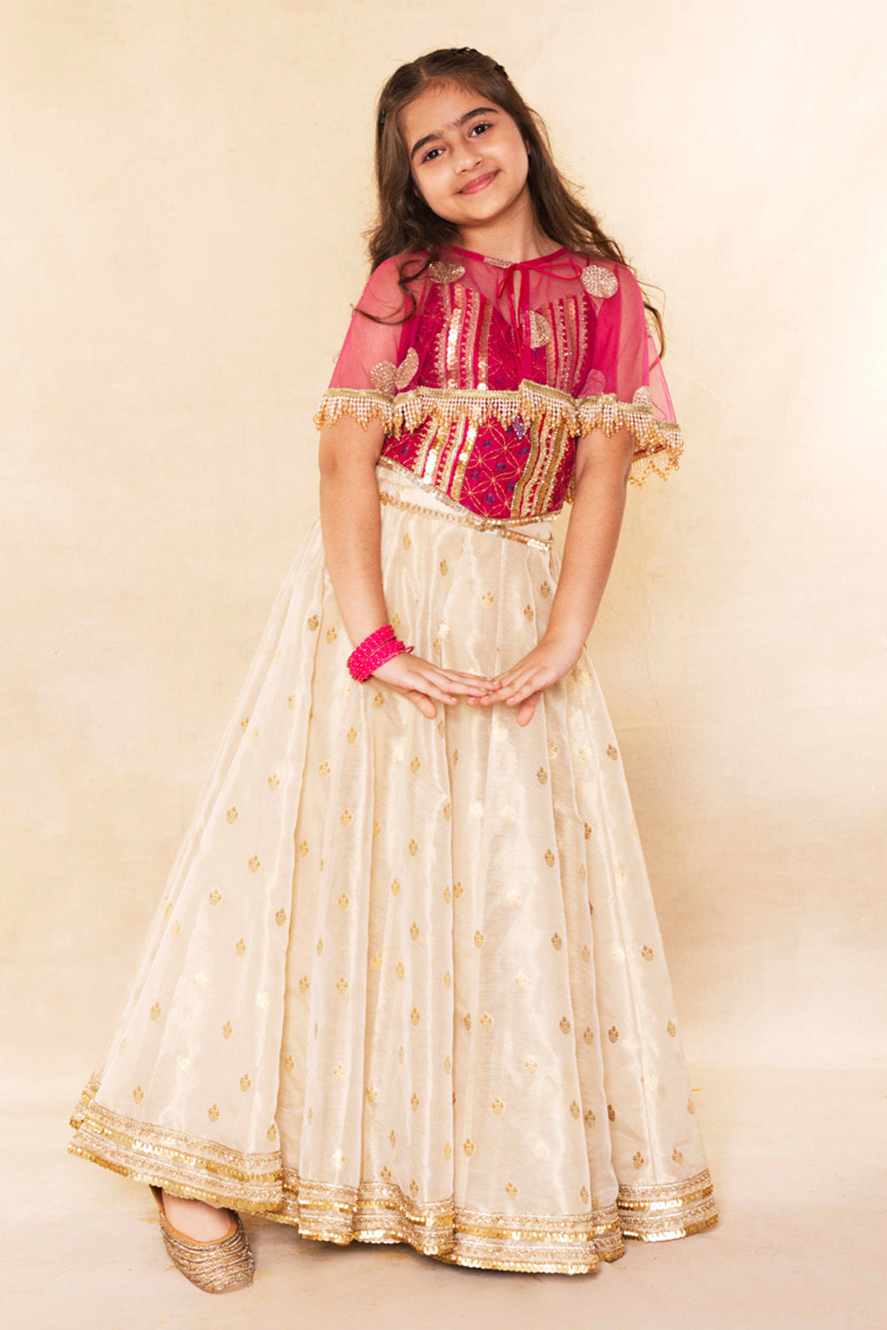 Fuchsia Corset Blouse With Embellished Cape and Gold Tissue Lehenga Set