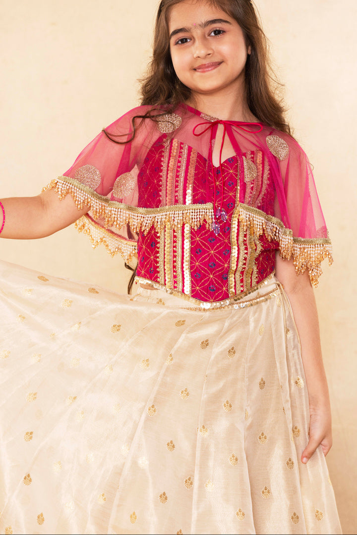 Fuchsia Corset Blouse With Embellished Cape and Gold Tissue Lehenga Set