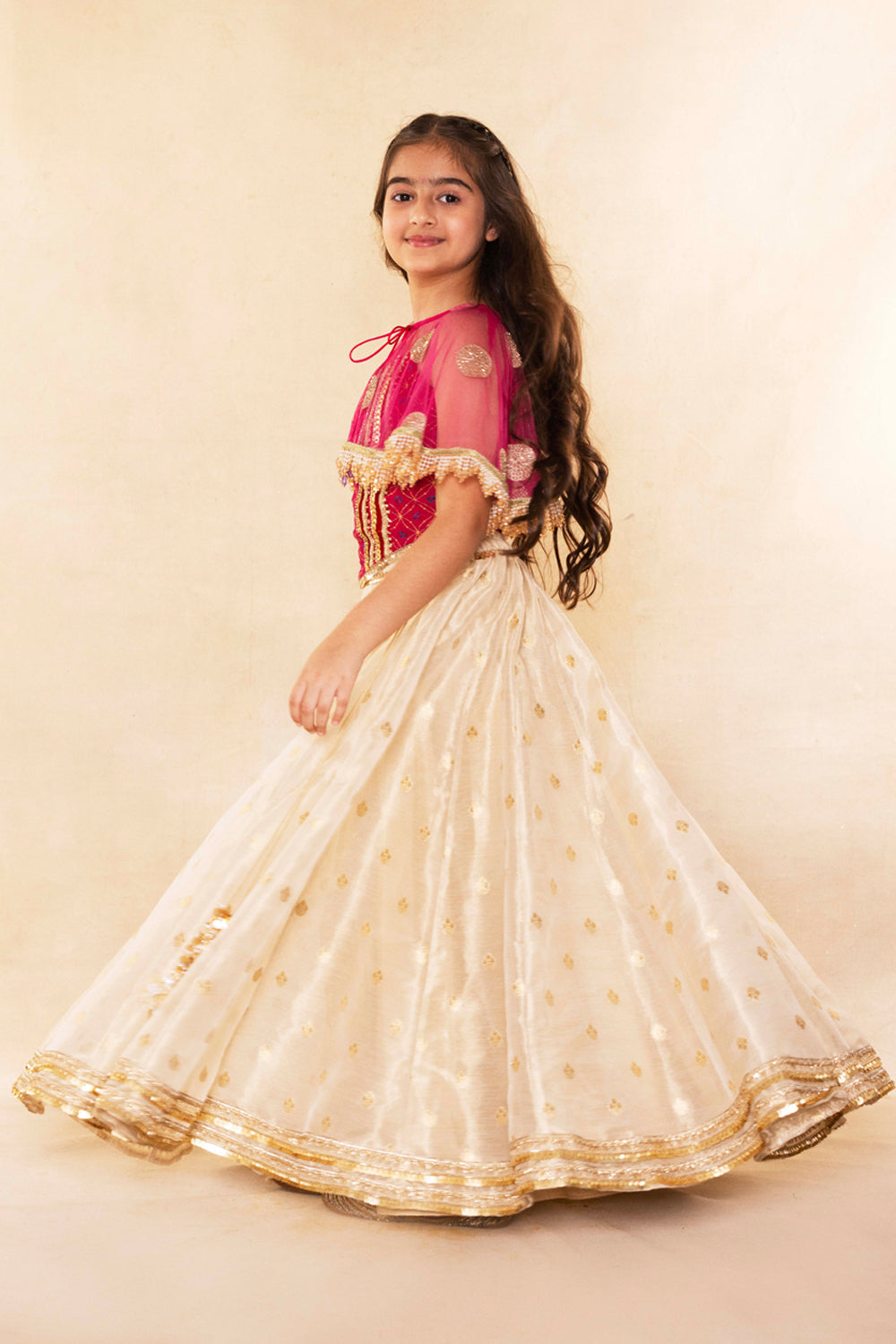 Fuchsia Corset Blouse With Embellished Cape and Gold Tissue Lehenga Set